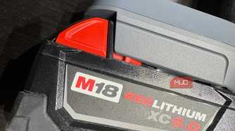A Milwaukee M18 battery attached to the Dyson V8 vacuum.