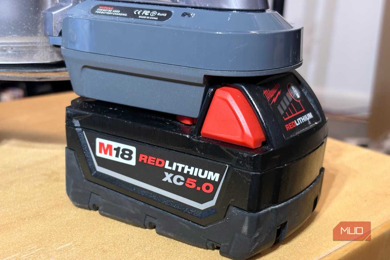 A Milwaukee M18 battery attached to the Dyson V8 vacuum.
