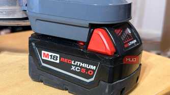A Milwaukee M18 battery attached to the Dyson V8 vacuum.