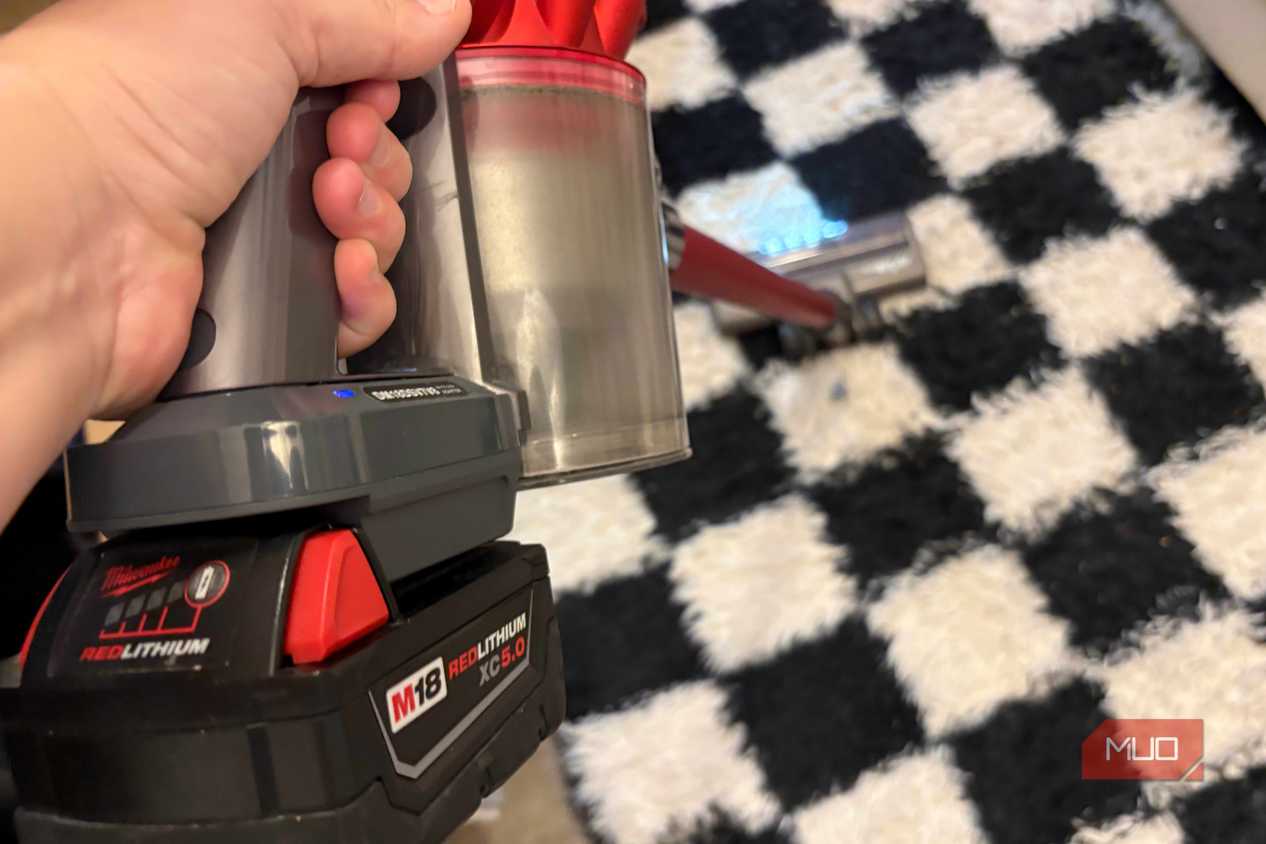 A Milwaukee M18 battery attached to the Dyson V8 vacuum.