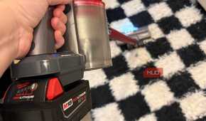 A Milwaukee M18 battery attached to the Dyson V8 vacuum.