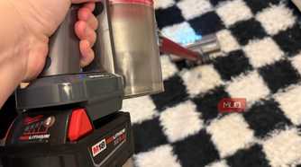 A Milwaukee M18 battery attached to the Dyson V8 vacuum.