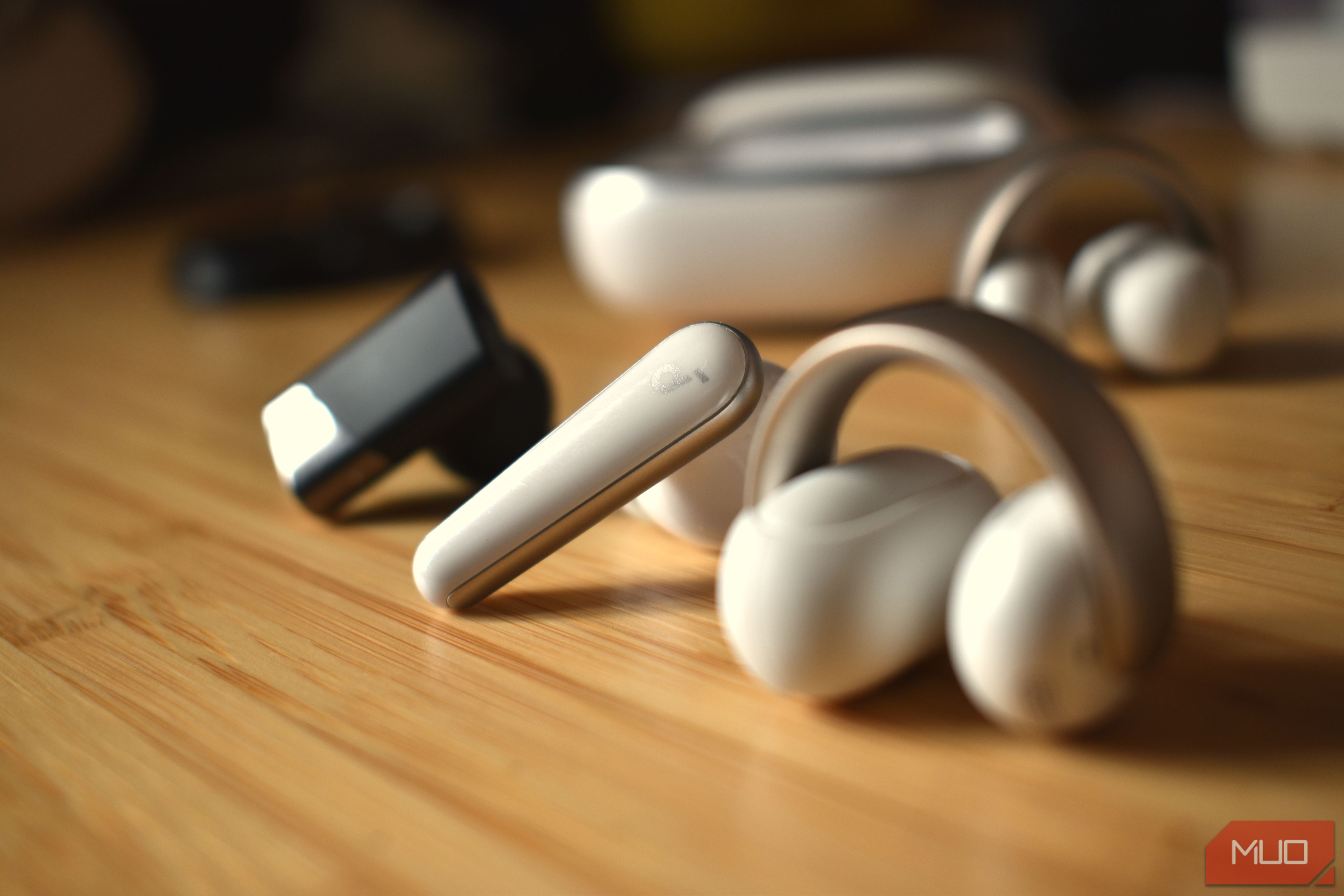 earbuds in a line on a table.