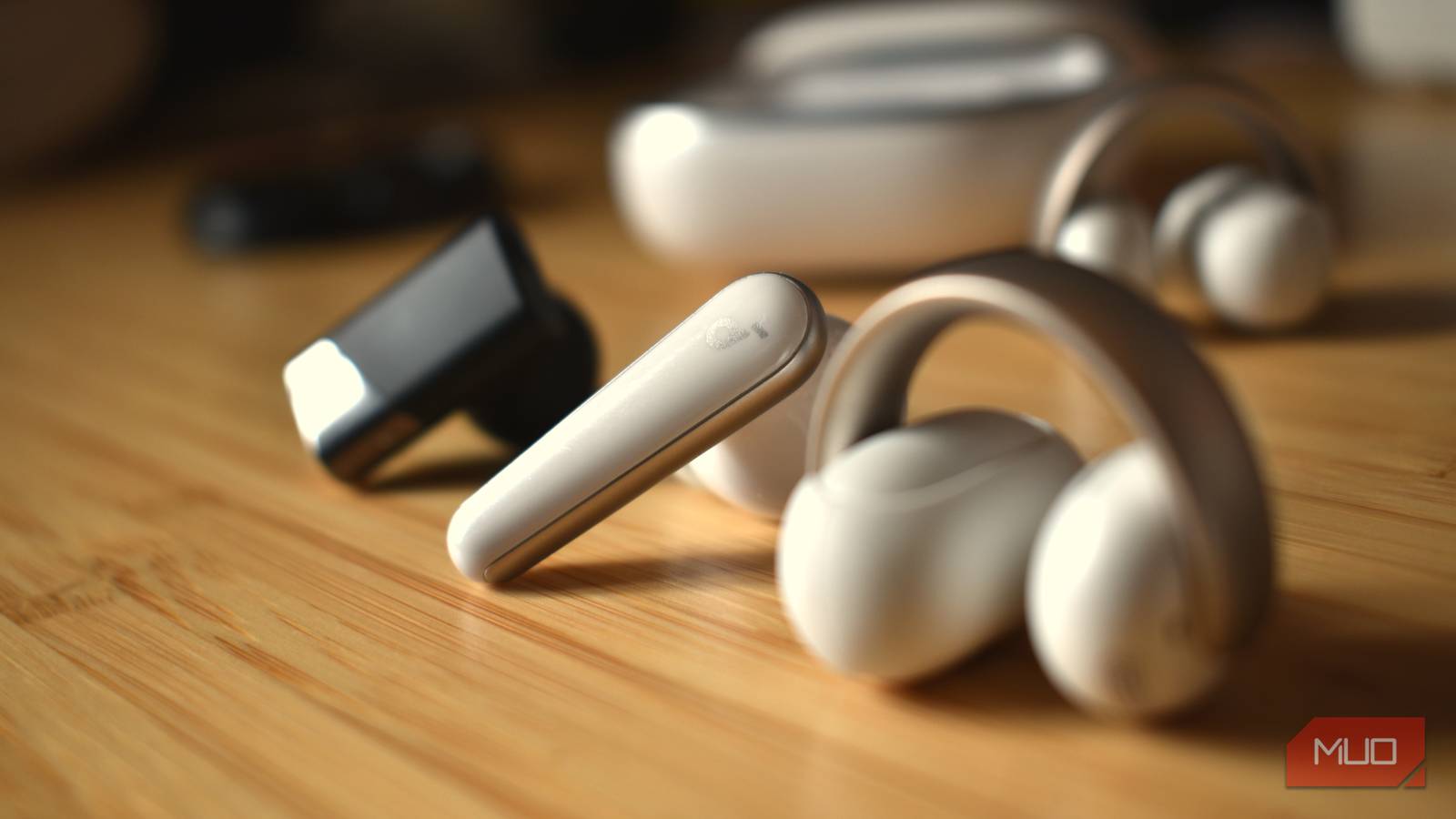 earbuds in a line on a table.