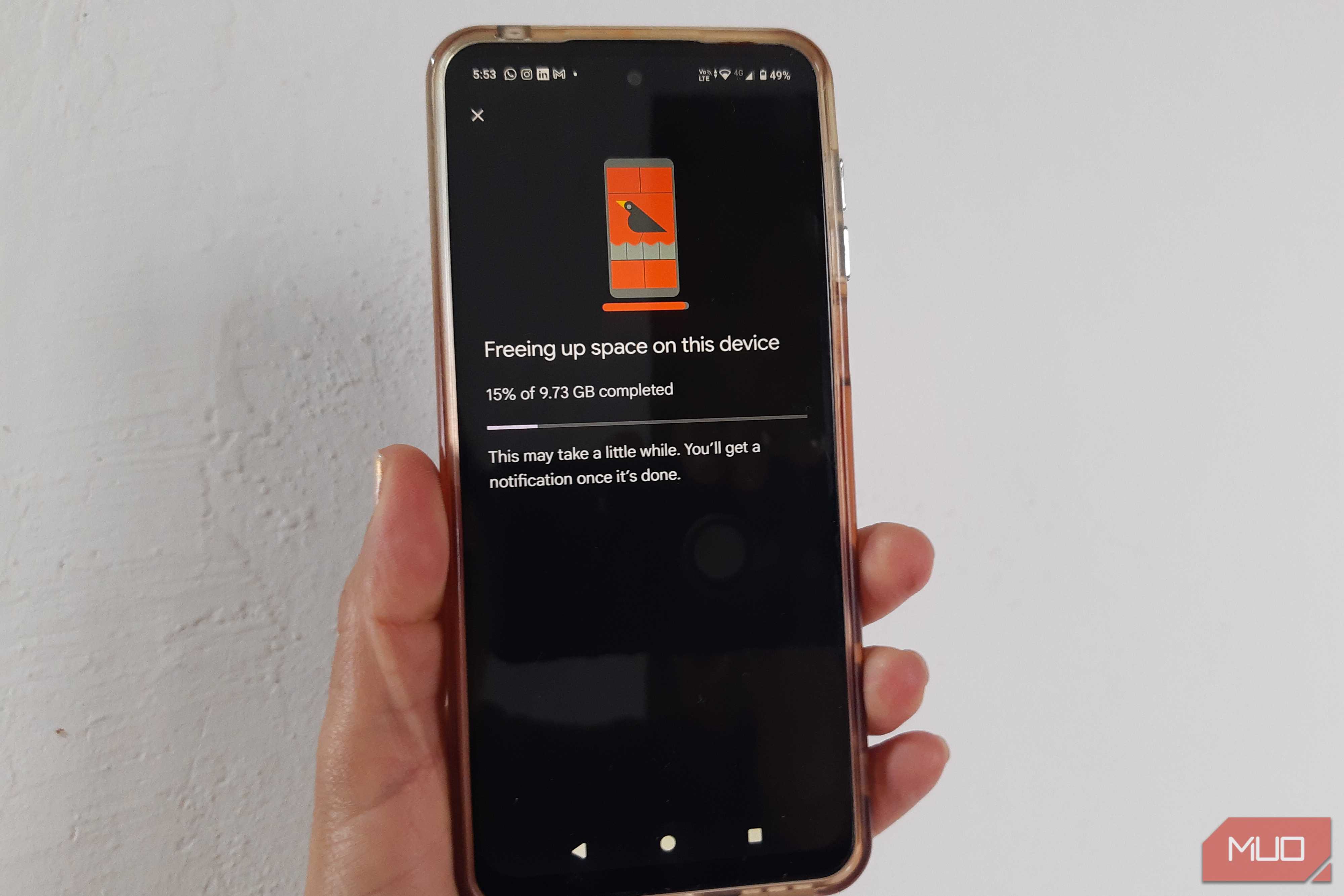 Android phone showing Google Photos at 15% while freeing up 9.73 GB of storage