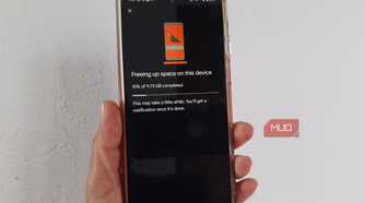 Android phone showing Google Photos at 15% while freeing up 9.73 GB of storage