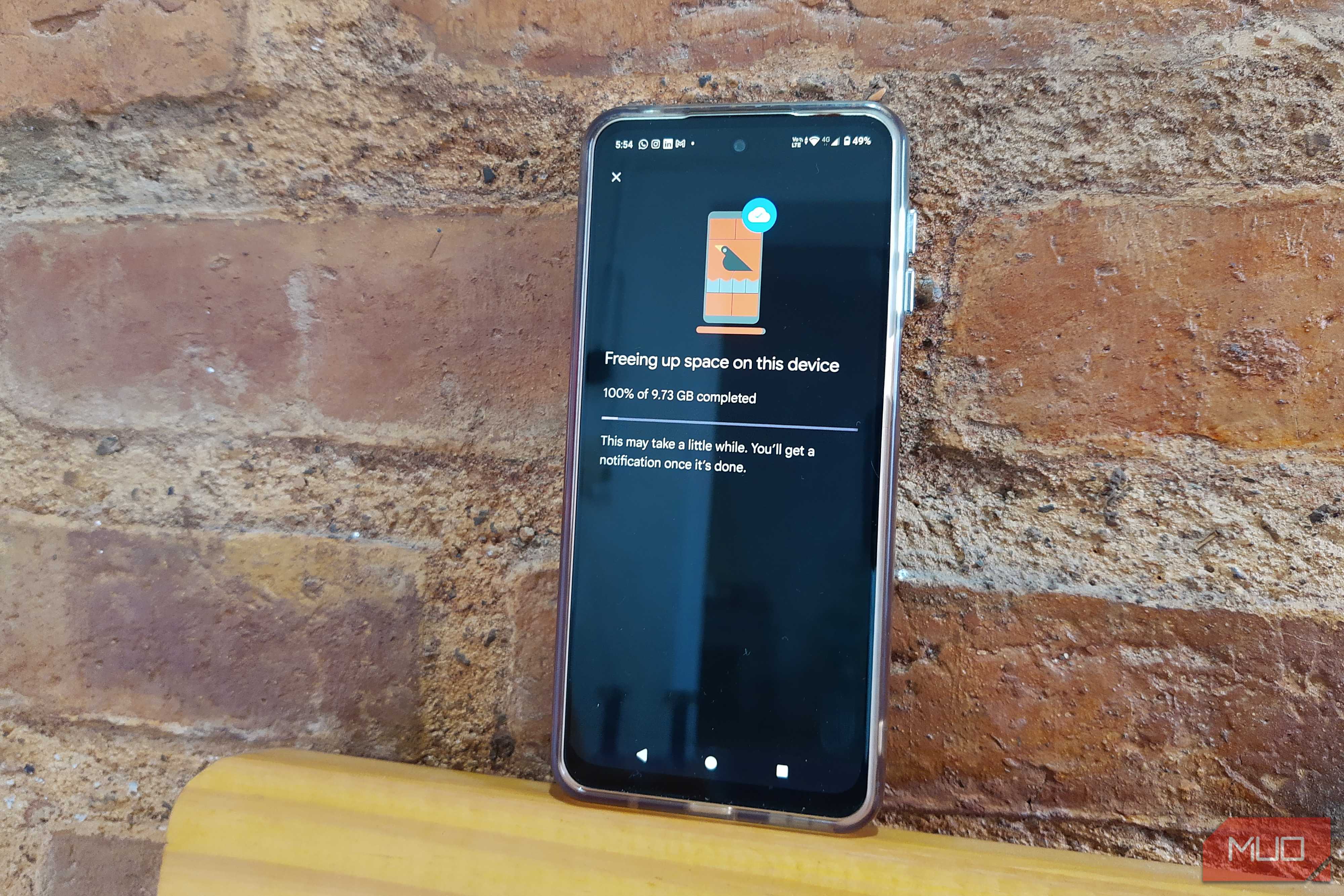 Android phone showing Google Photos at 100% after freeing up 9.73 GB of storage
