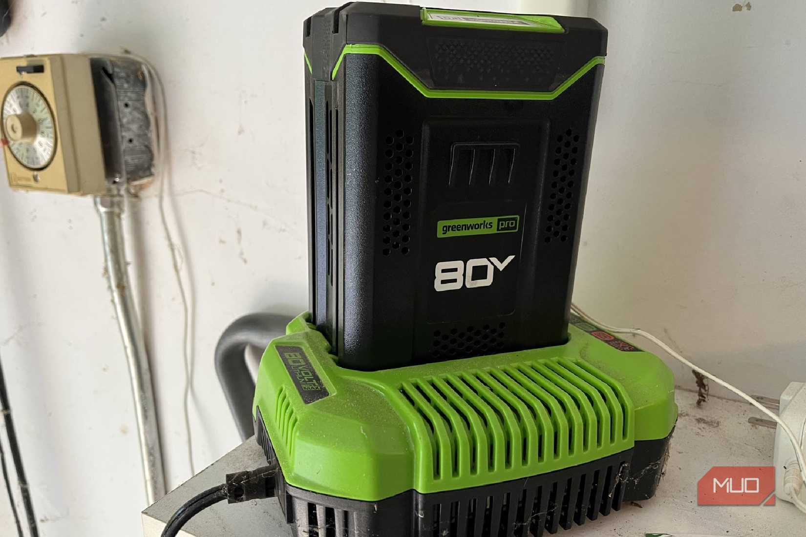 A Greenworks 80V battery in its charger