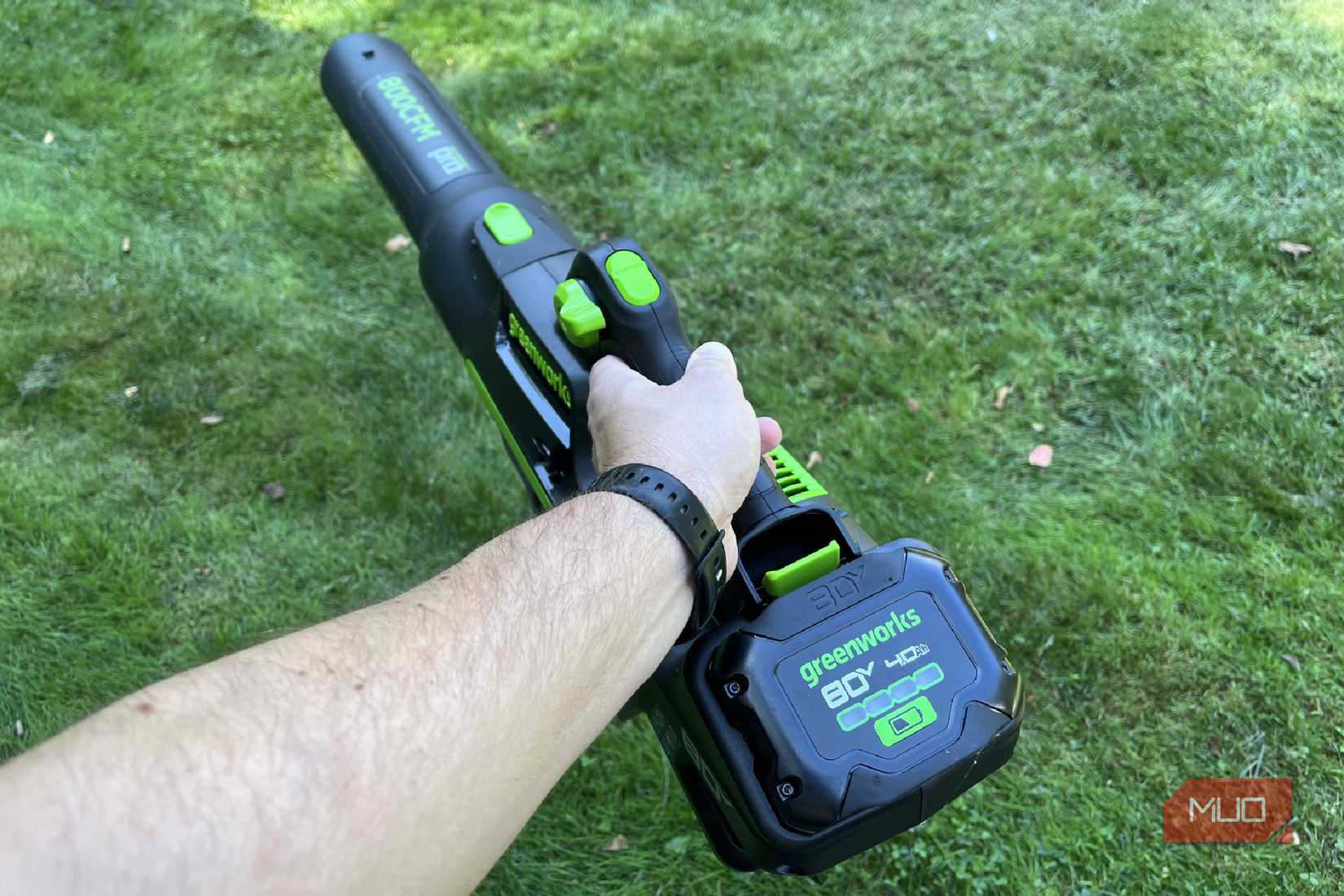 Holding a Greenworks 80V 800CFM blower