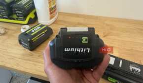 hand holding off-brand ryobi 40V battery showing charge indicator lights