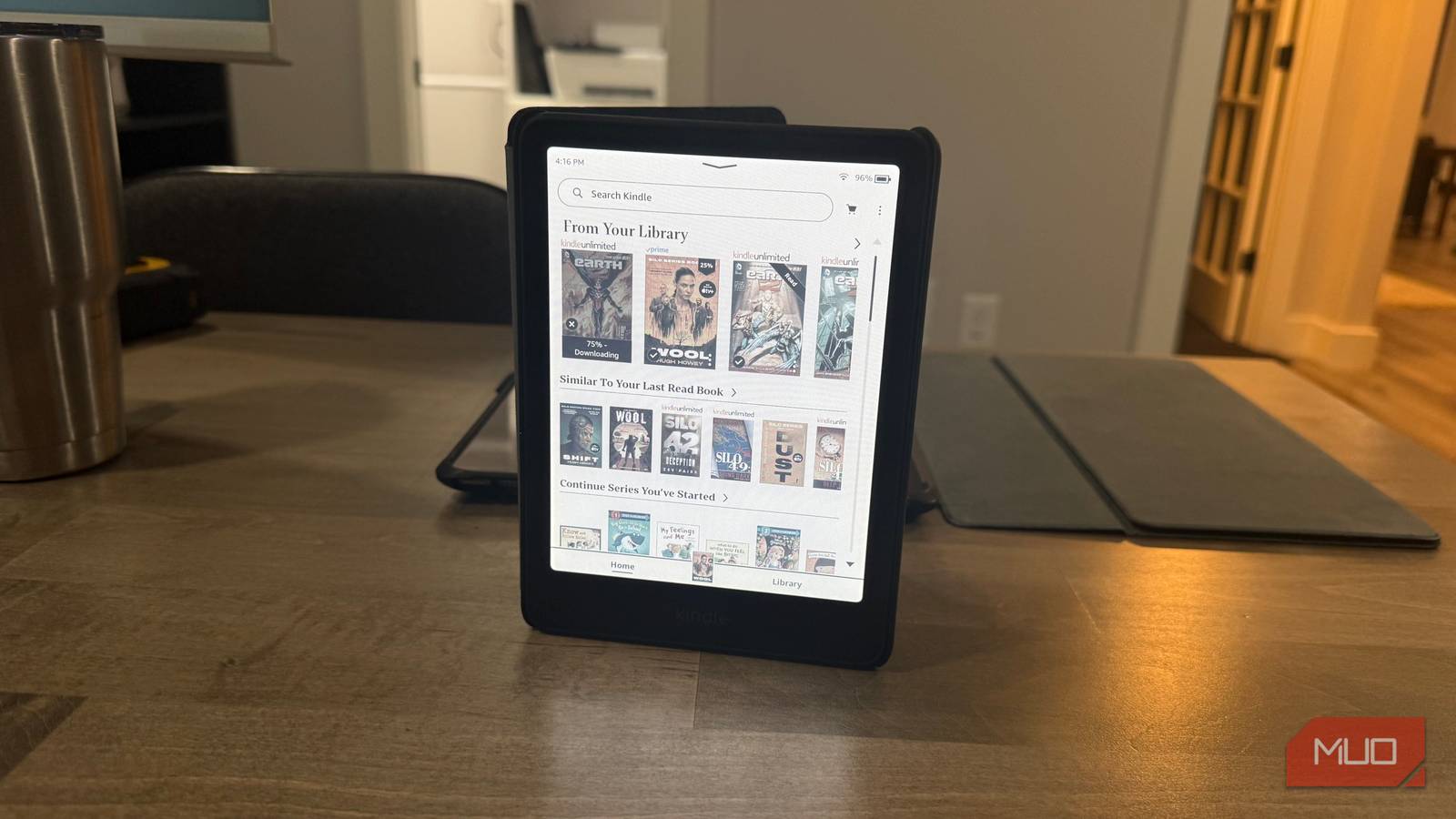 Ридер Kindle Colorsoft на подставке с цветной библиотекой