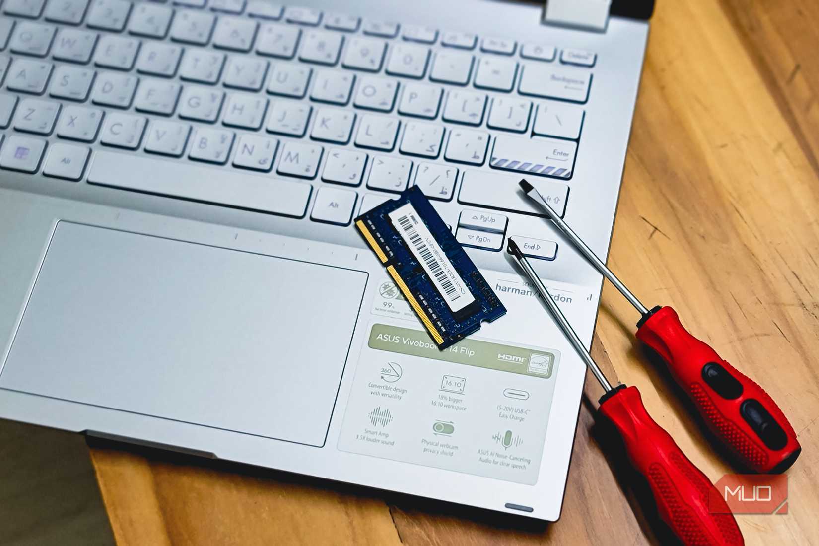laptop ram memory upgrade with screwdrivers on wooden desk