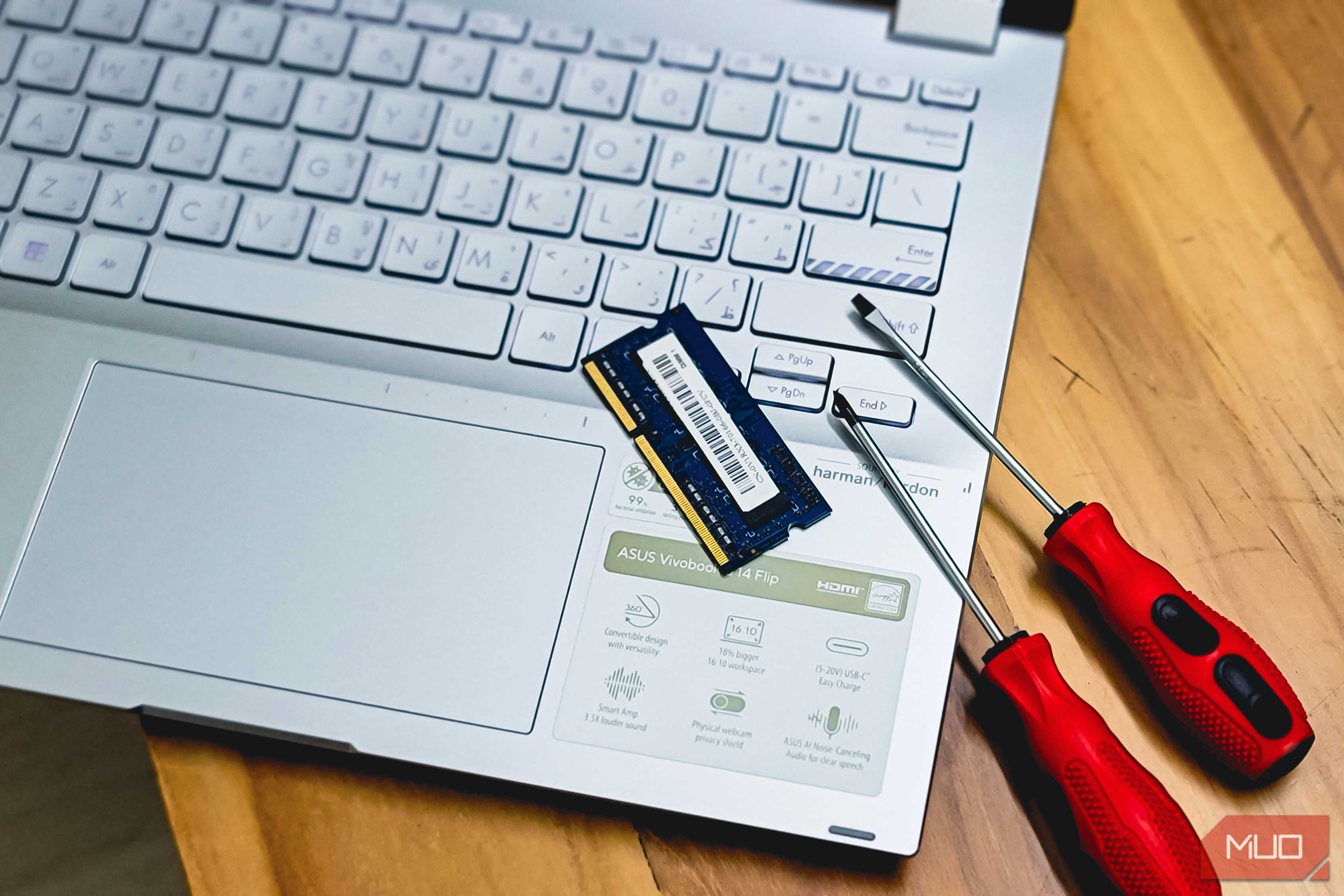 laptop ram memory upgrade with screwdrivers on wooden desk
