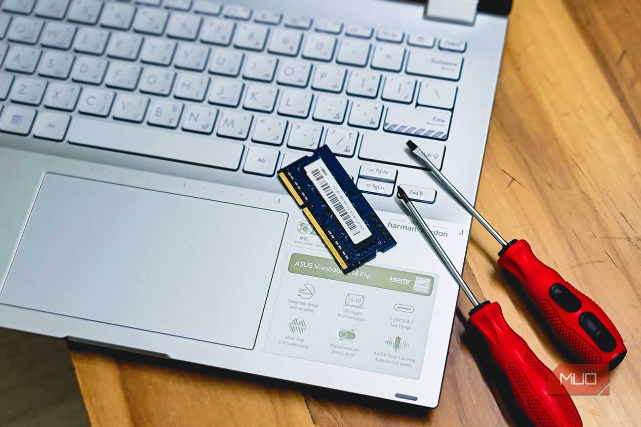 laptop ram memory upgrade with screwdrivers on wooden desk