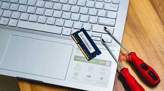 laptop ram memory upgrade with screwdrivers on wooden desk