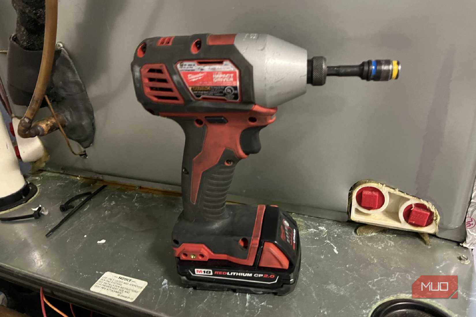 A Milwaukee drill with a M18 REDLITHIUM CP 2.0 battery