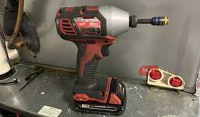 A Milwaukee drill with a M18 REDLITHIUM CP 2.0 battery