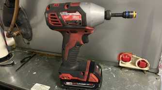 A Milwaukee drill with a M18 REDLITHIUM CP 2.0 battery