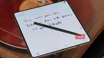 The Moto Pen Ultra lying on the Razr Fold.