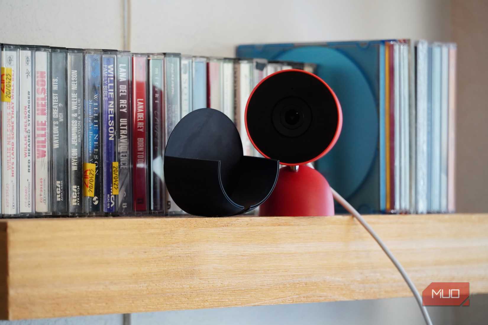 A 3D-printed camera cover beside the Nest Cam Indoor. 