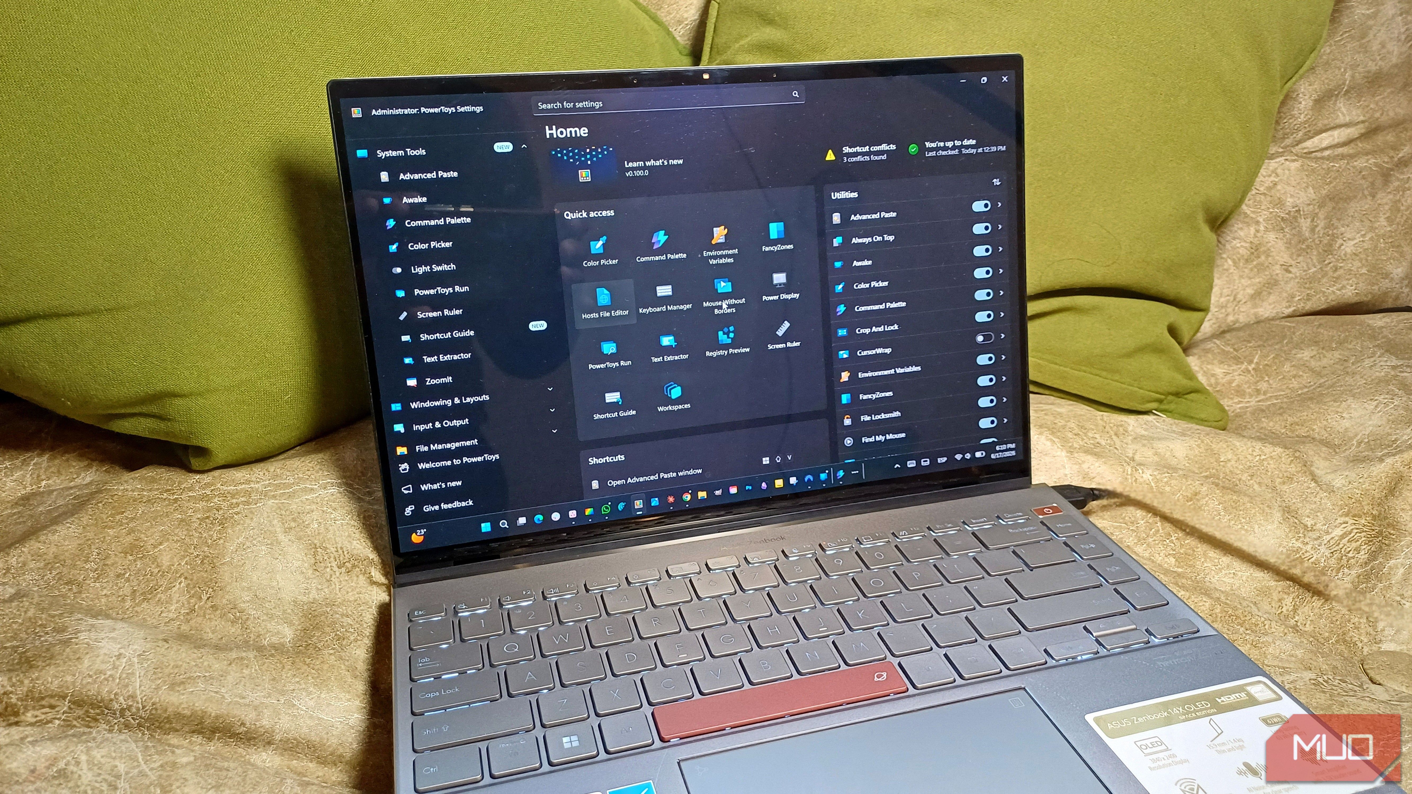Laptop displaying the PowerToys Settings home screen, with utilities such as Shortcut Guide, FancyZones, Color Picker, and PowerToys Run visible