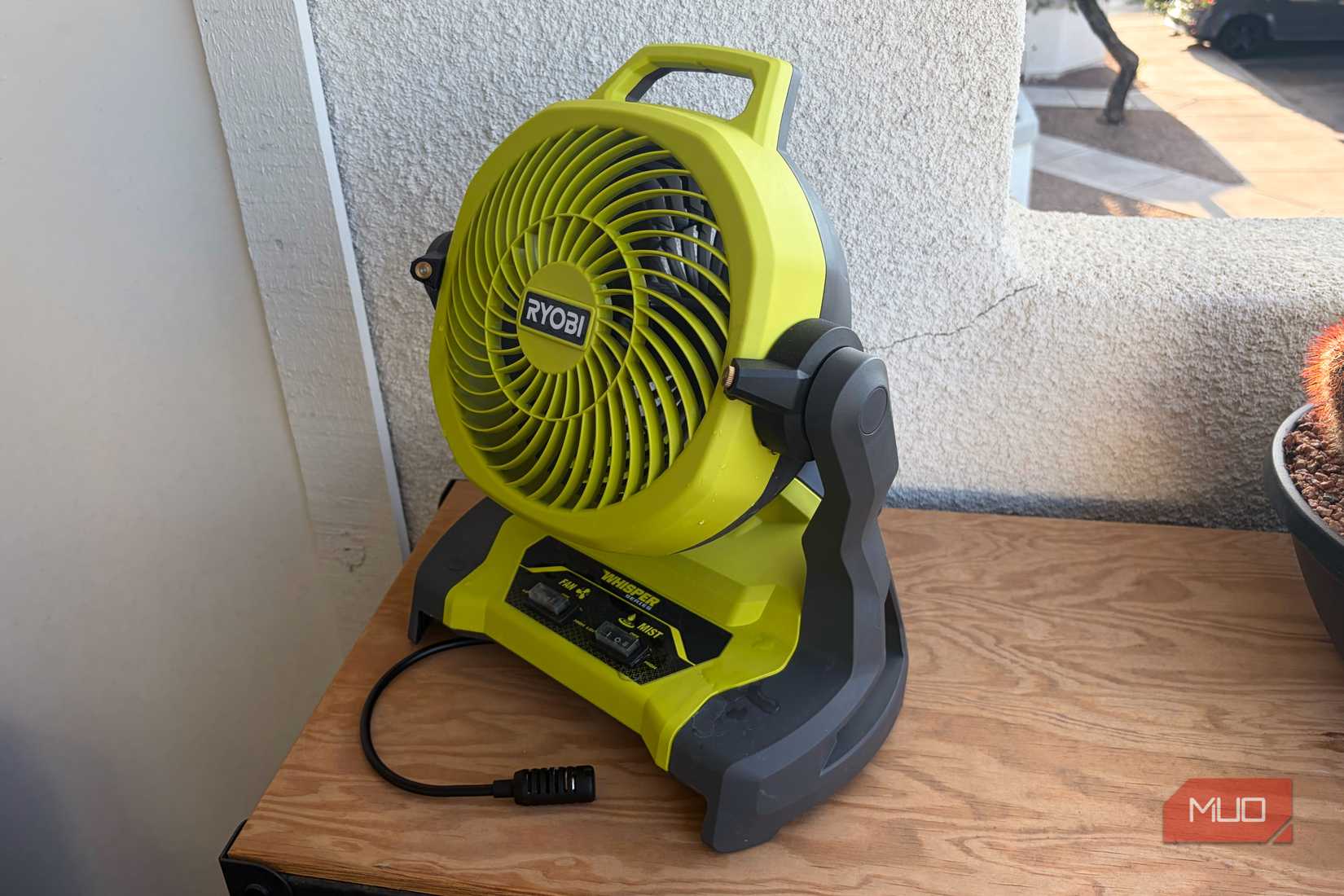 The Ryobi bucket top misting fan on a tool chest.