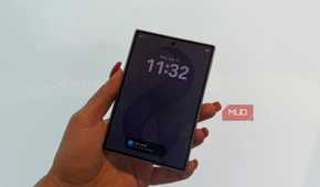 The Samsung Galaxy Z Fold 8 in hand closed in front of a white wall.