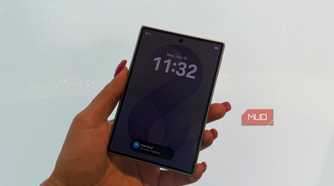 The Samsung Galaxy Z Fold 8 in hand closed in front of a white wall.