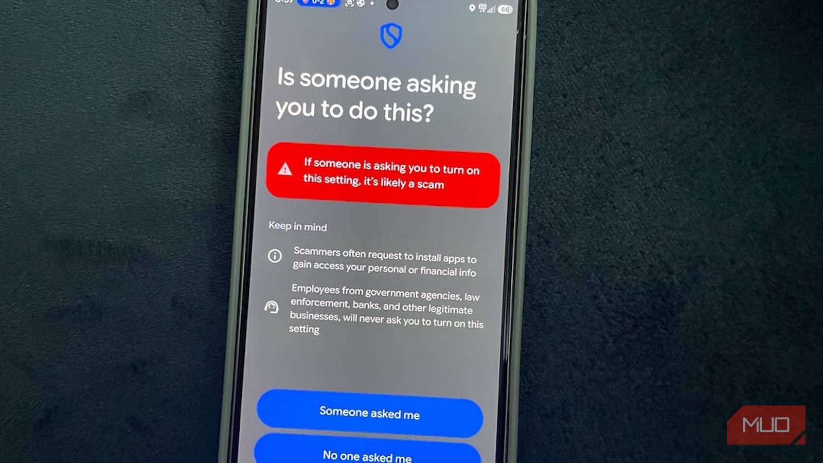 Smartphone screen warning about potential scam alert