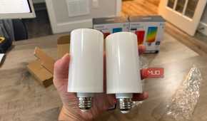Two Linkind Smart Light Stick bulbs held in hand showing E26 base