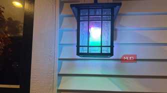Wall lantern glowing in mixed colors with a Linkind smart bulb 2