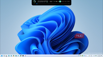 windows 11 blue abstract flower wallpaper with music player overlay