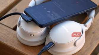 A pair of USB-C headphones connected to an Android phone.