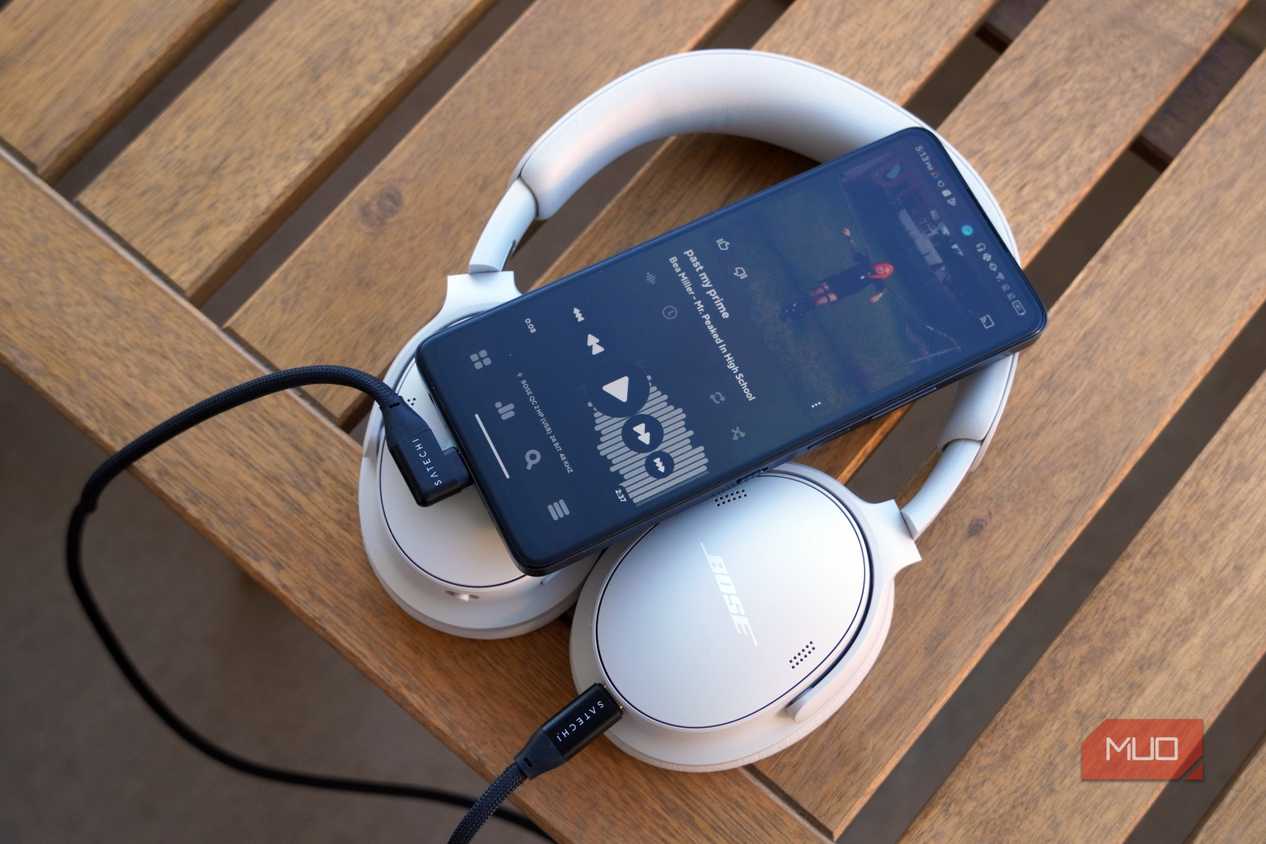 A pair of USB-C headphones connected to an Android phone.