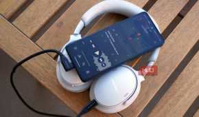 A pair of USB-C headphones connected to an Android phone.