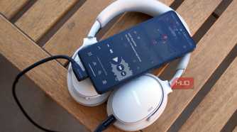 A pair of USB-C headphones connected to an Android phone.