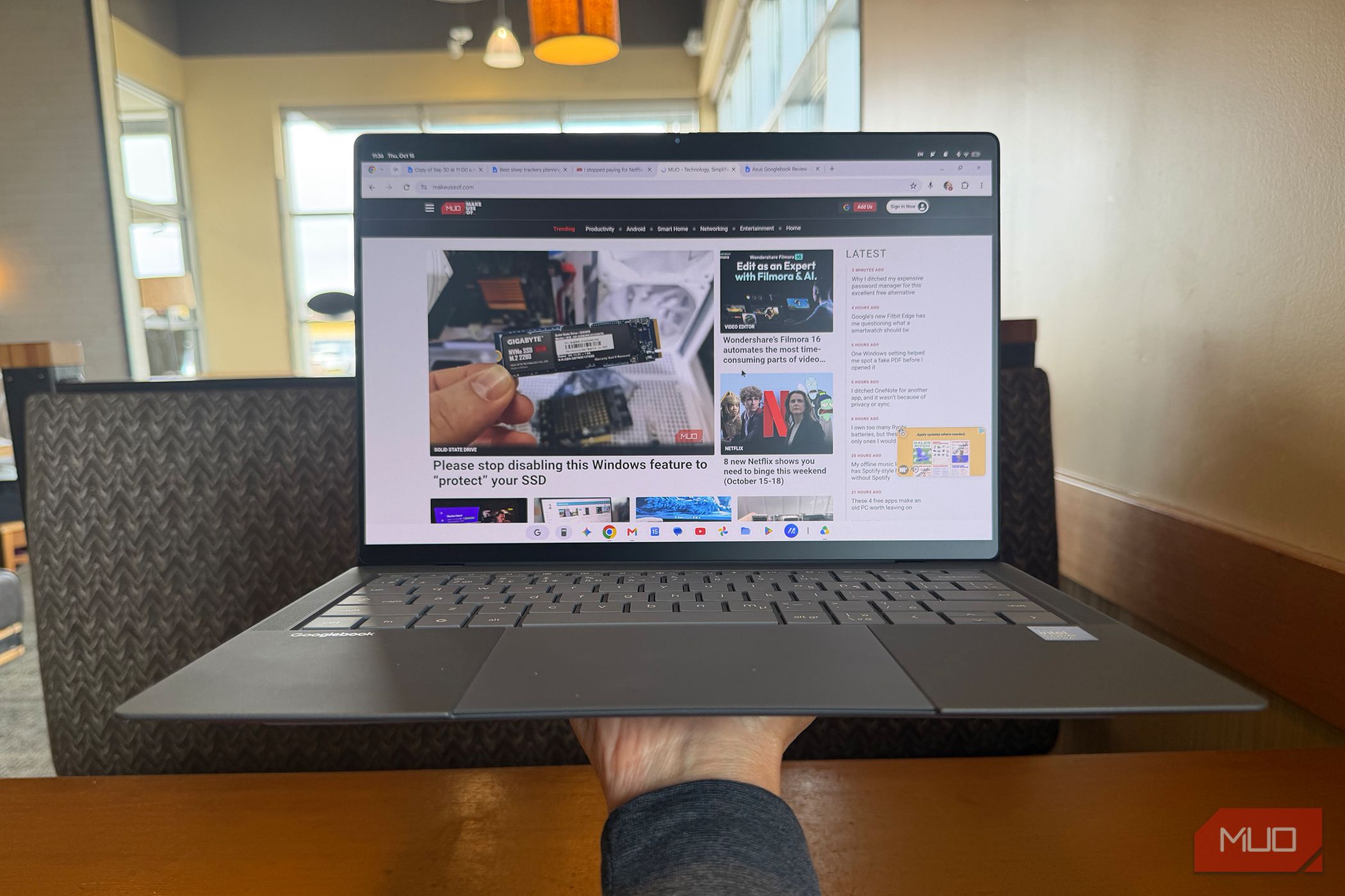 A hand holding up the Asus Googlebook 14