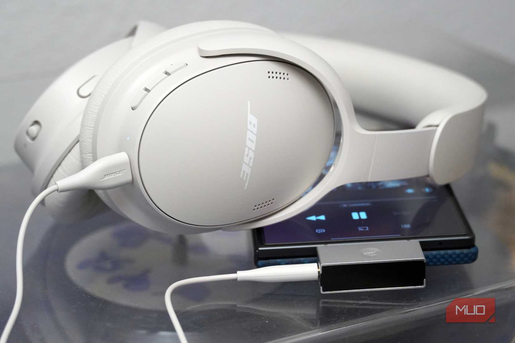 The Bose QuietComfort 2 headphones in white connected to a DAC.