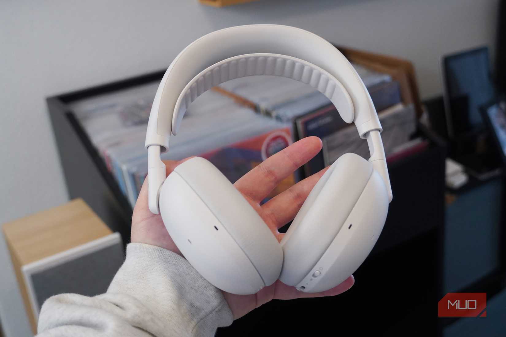 The Logitech Zone Vibe Pro headset in the off-white colorway in the hand.