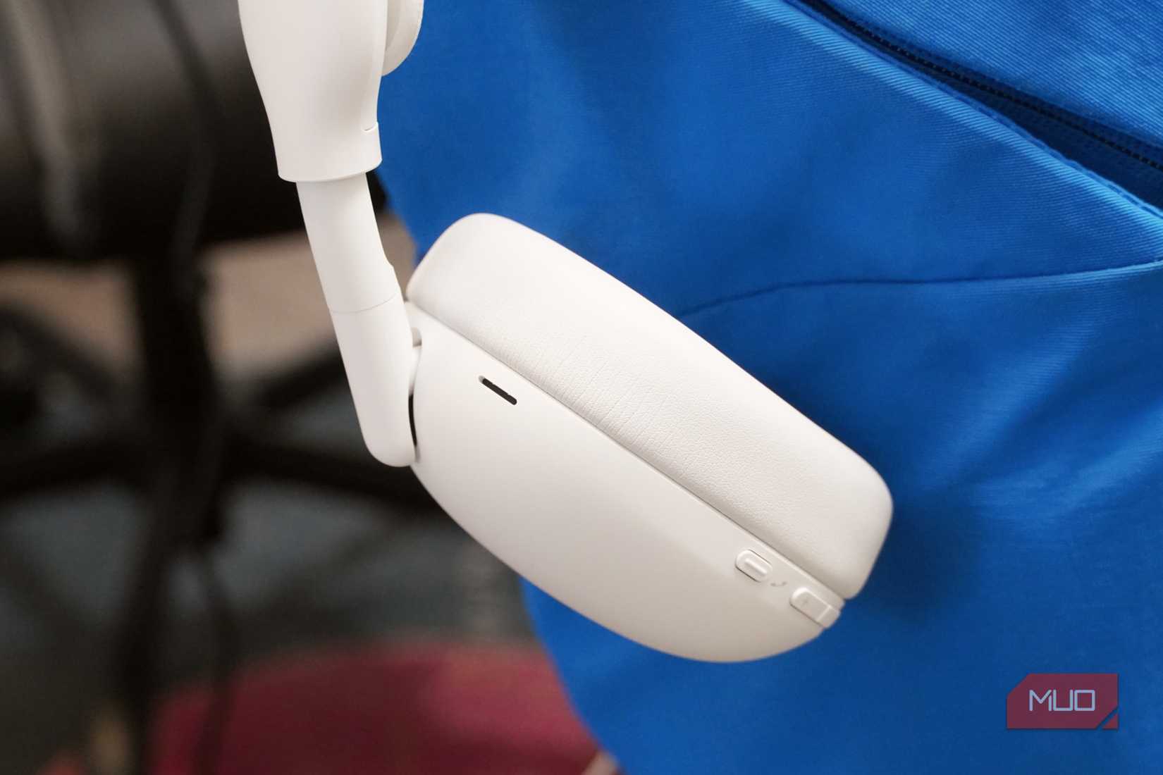 The Logitech Zone Vibe Pro headset in the off-white colorway showing the controls.