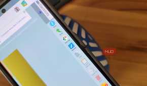 phone file manager showing download folder with action menu on wooden desk