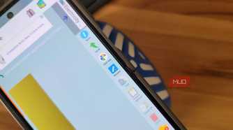phone file manager showing download folder with action menu on wooden desk