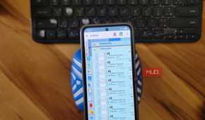 phone file manager showing electricity bill billdesk payment pdfs on wooden desk