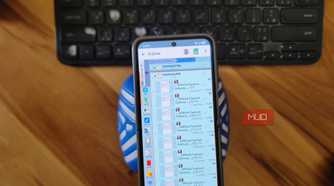phone file manager showing electricity bill billdesk payment pdfs on wooden desk