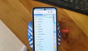 phone showing x plore file manager browsing internal shared storage folders on wooden desk