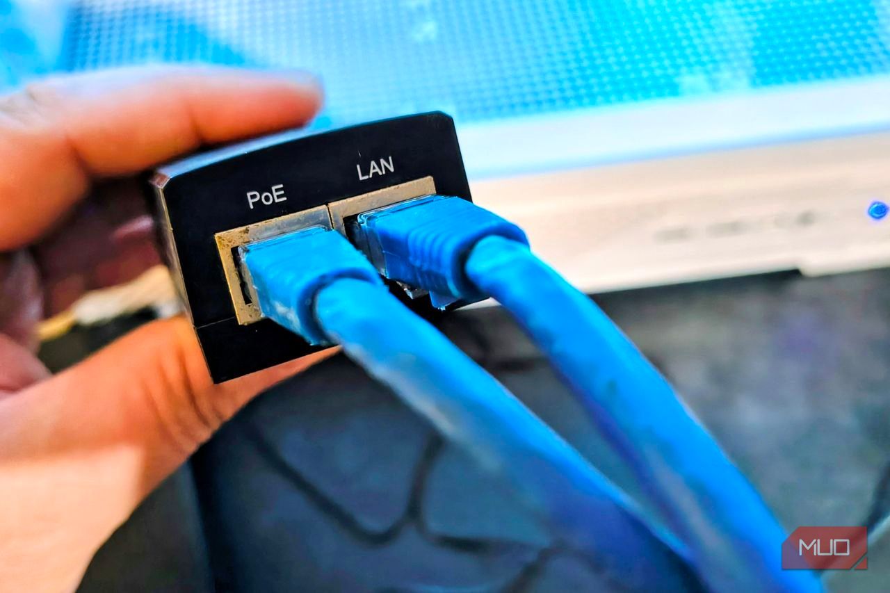 TP-Link PoE injector with Ethernet cables connected to its LAN and PoE ports