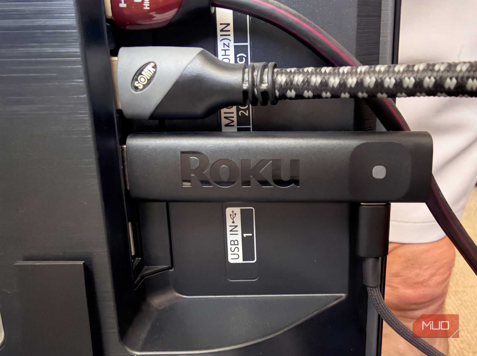 A Roku Stick in the back of a television.