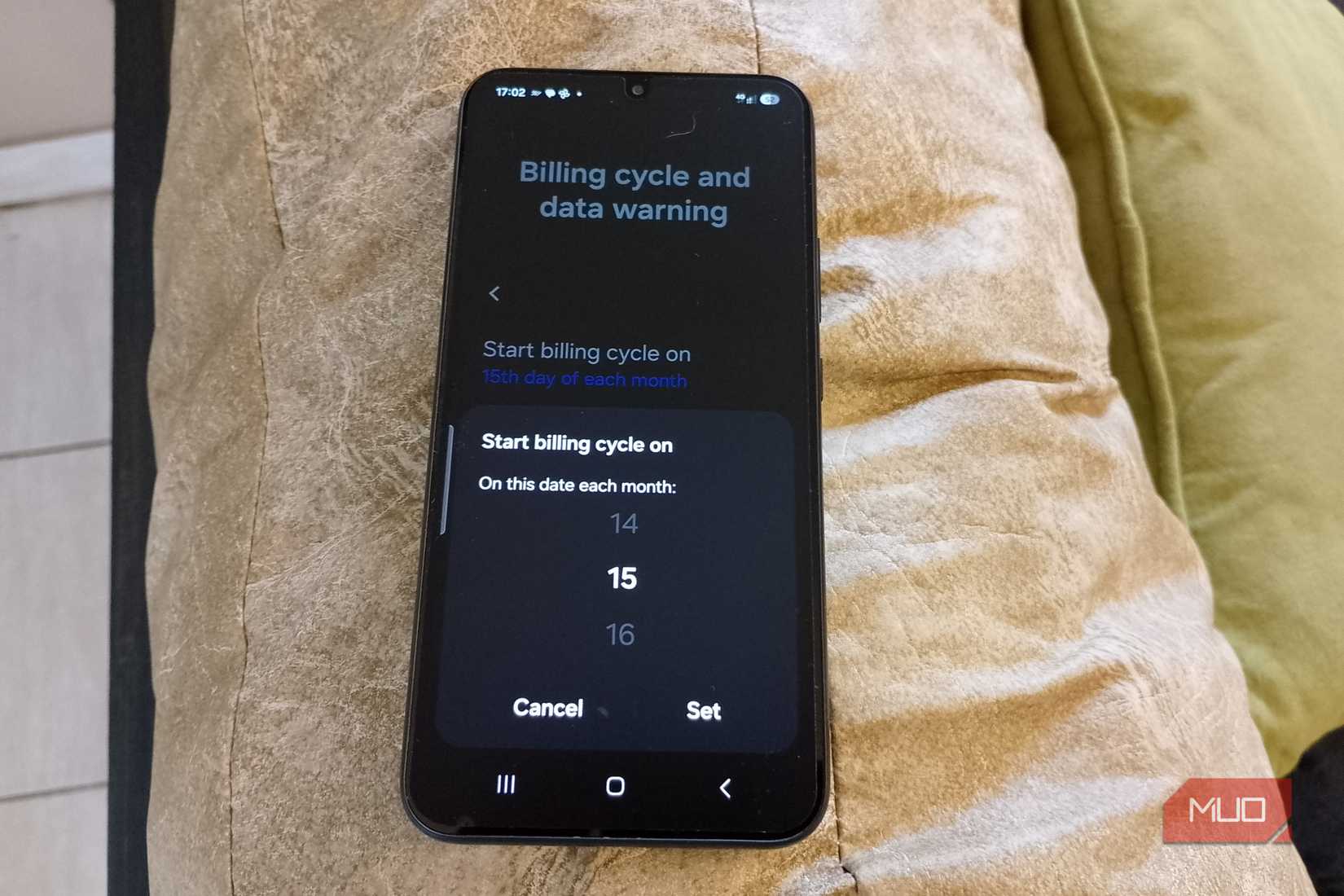 Galaxy phone lying on couch showing starting billing date for the 15th