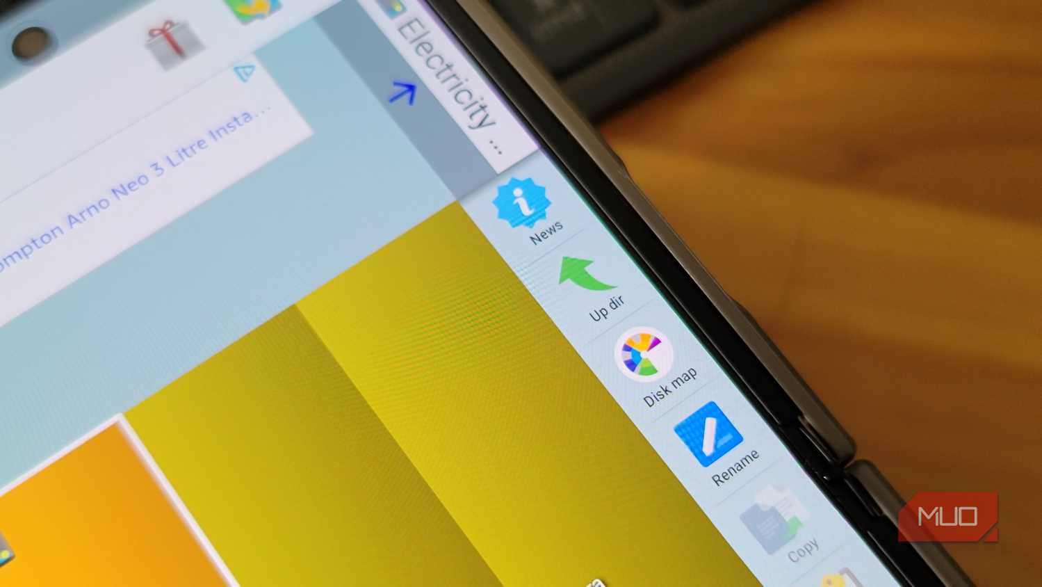 tablet screen showing file manager with disk map rename and copy options beside an advert