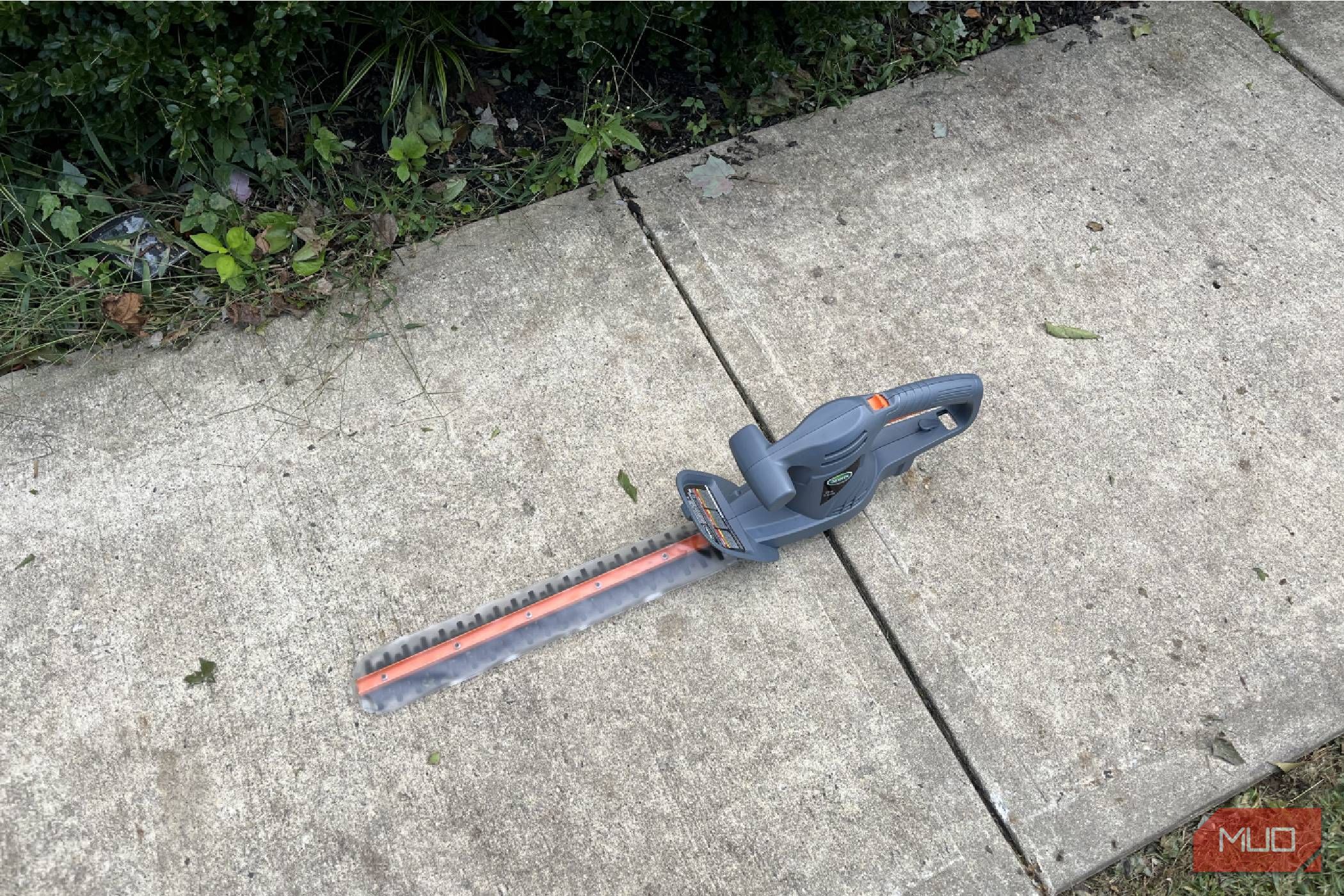 The sidewalk with a Scotts Corded Hedge Trimmer